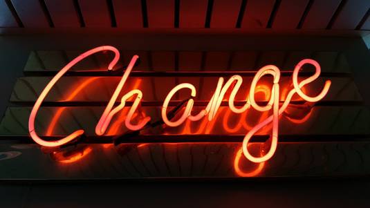 A neon sign where you can read the word Change