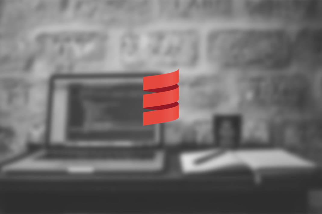 A black and white image of a laptop and a notebook faded and on the middle of the image there is the Scala logo in red for the post 5